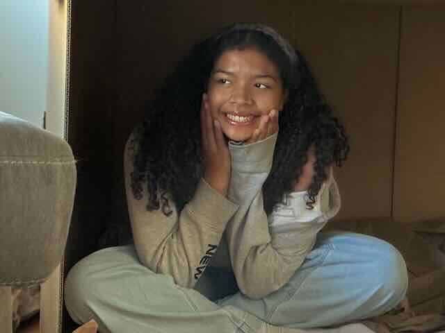 Say smiling in a cozy outfit